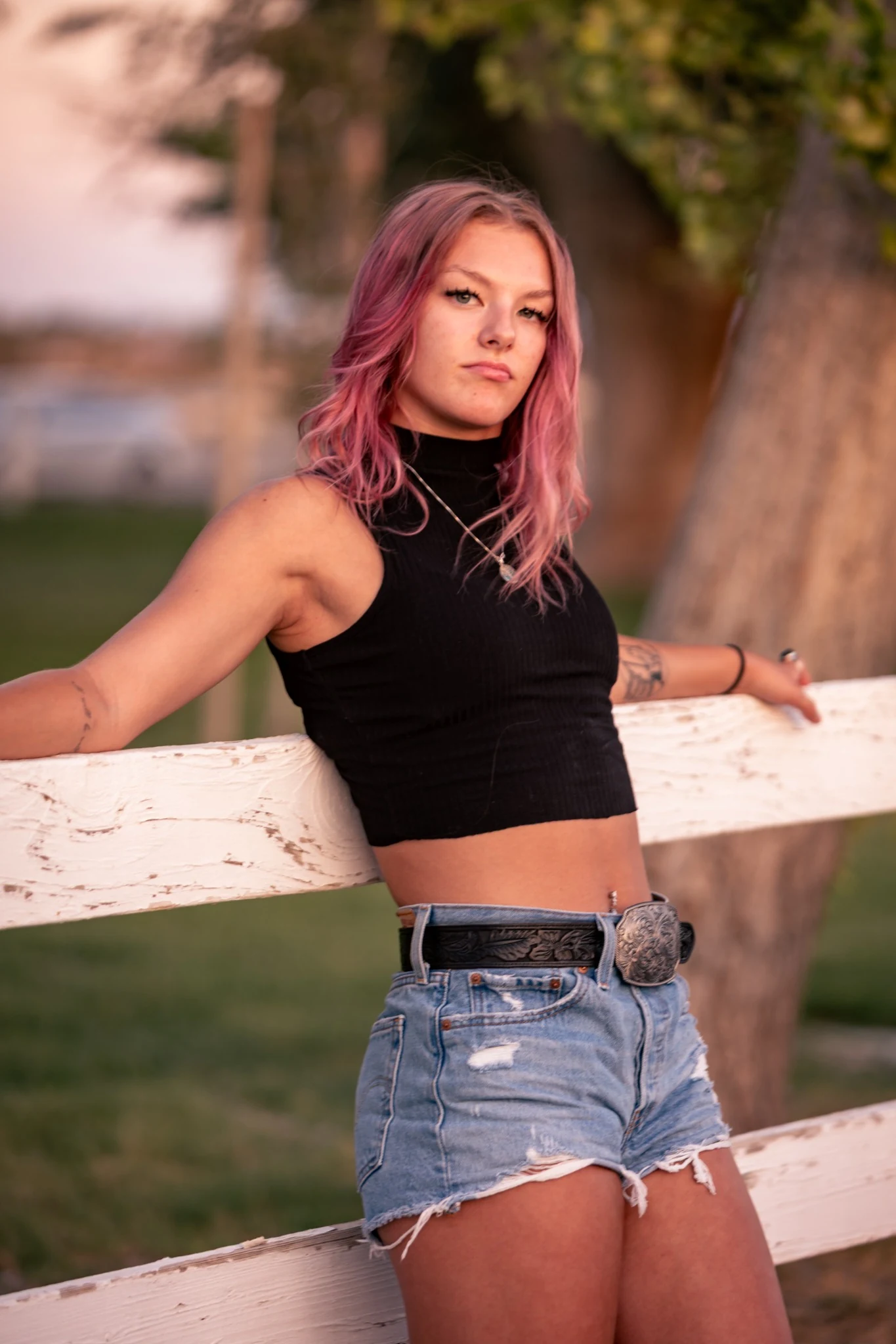 Outdoor portrait at a white fence