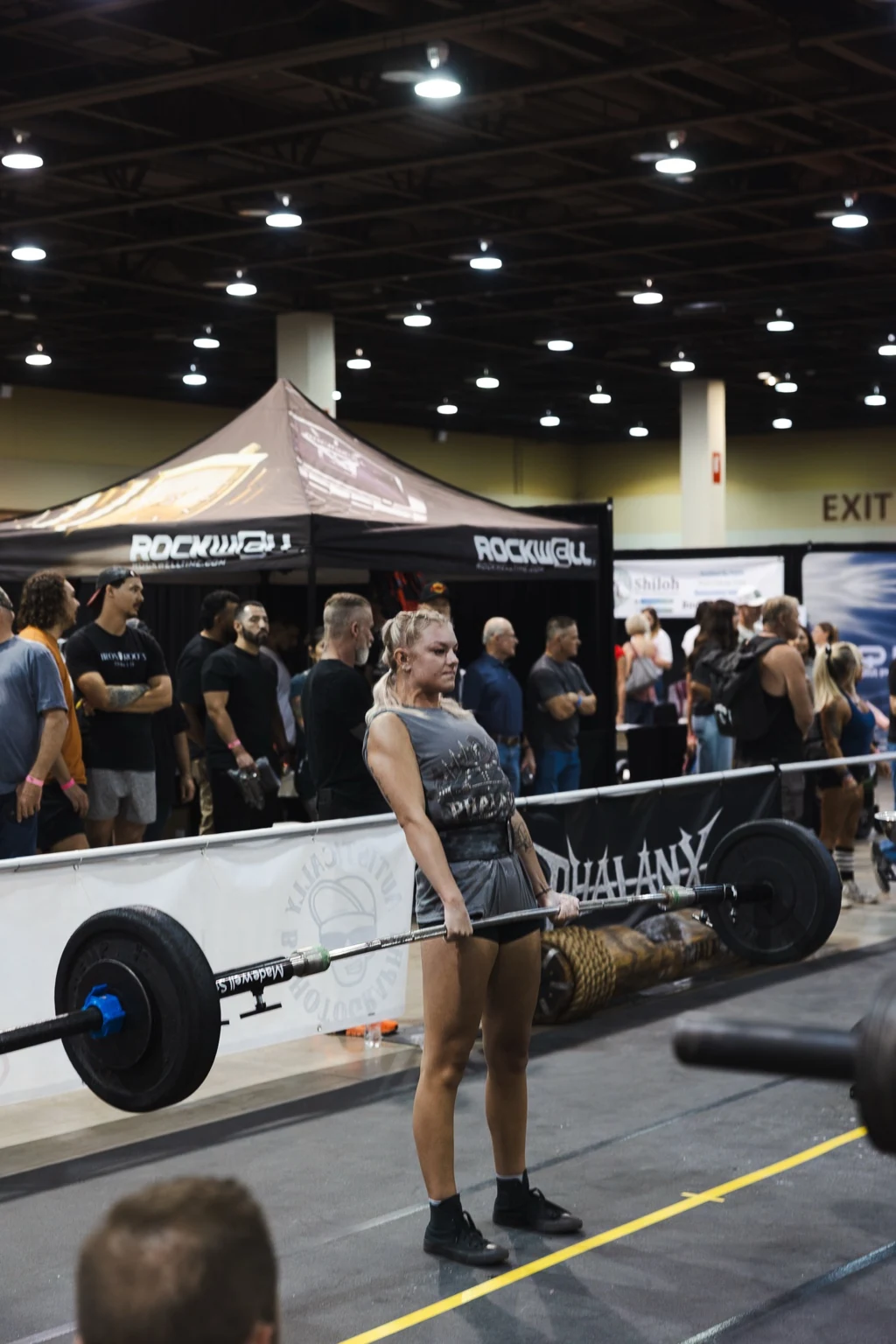 Strongwoman athlete competing in a barbell event