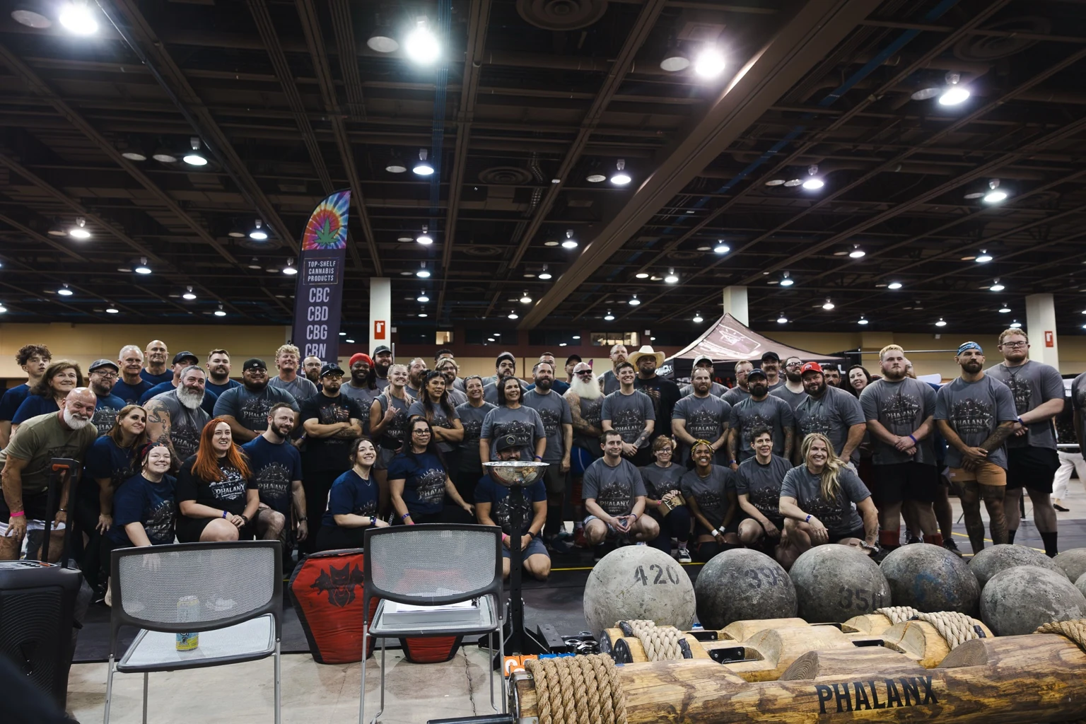 Strongman competition group photo with event equipment in the foreground