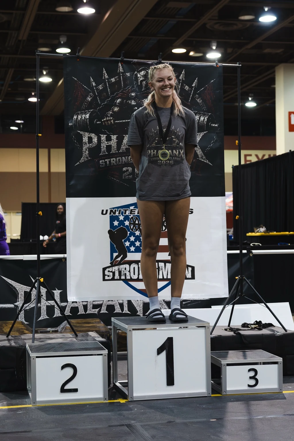 Strongwoman athlete smiling on the first-place podium
