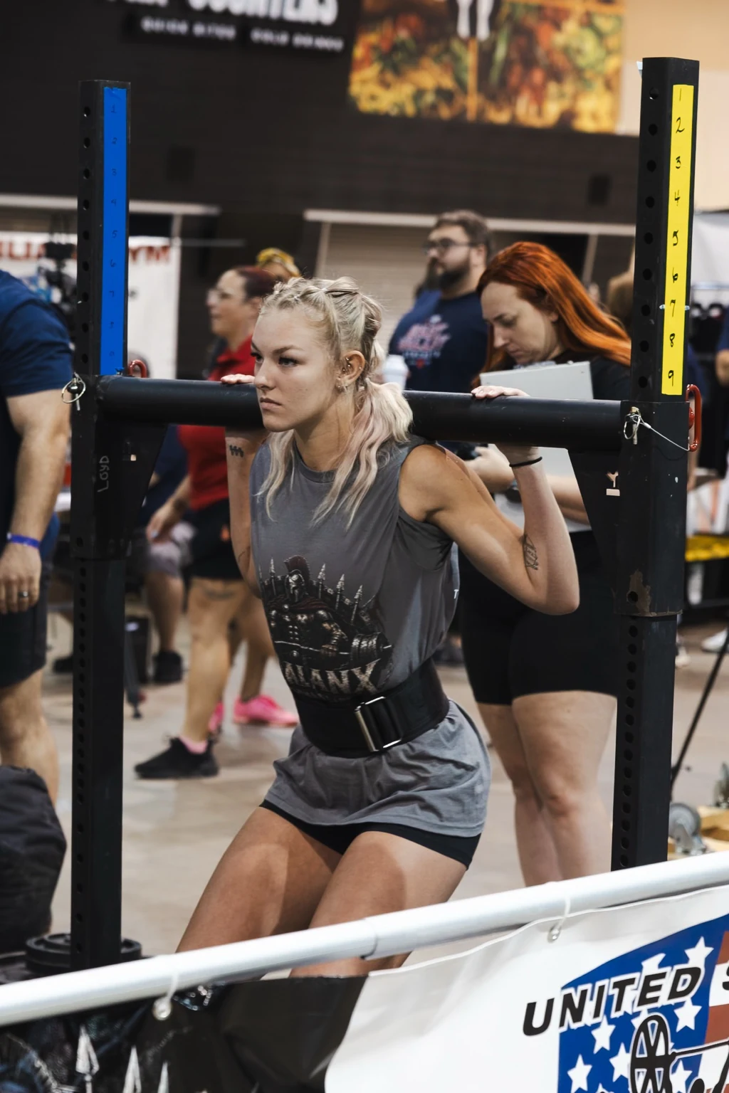 Strongwoman athlete under a yoke during competition